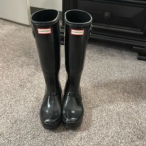 Glossy black tall hunter boots